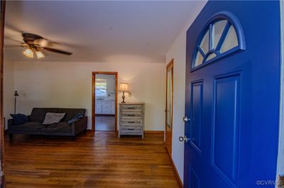 Foyer entrance featuring dark wood-type flooring and ceiling fan | Image 2