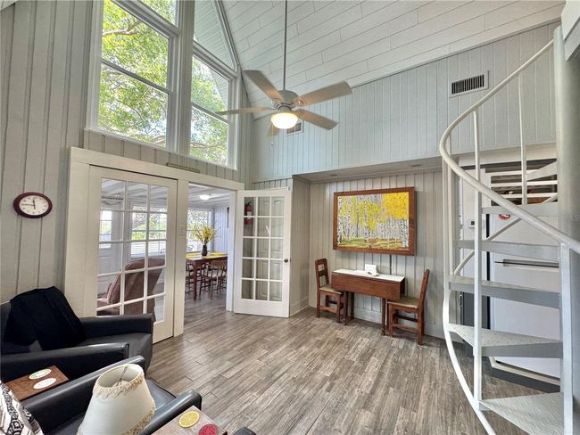 Living room with spiral stairs to loft bedroom | Image 8