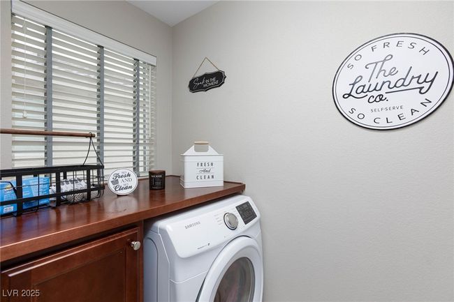 Clothes washing area featuring laundry area, washer / clothes dryer, and a healthy amount of sunlight | Image 28