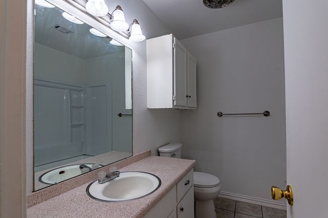 1214 Hunt - Full bath with tile patterned floors, toilet, a shower, vanity | Image 10