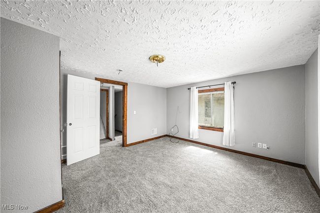 Empty room featuring a textured ceiling and carpet floors | Image 13