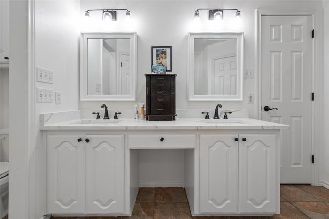 Bathroom with a sink, double vanity, and stone tile floors | Image 16