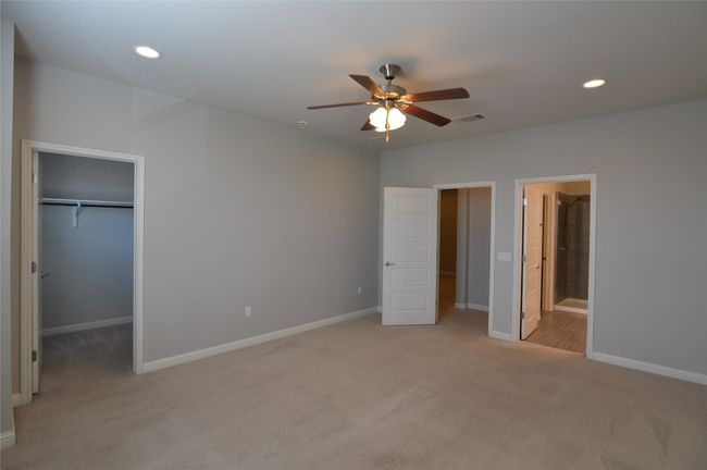 Bedroom 1 of 3 w walk in closet baseboards, recessed lighting, and connected bathroom | Image 5