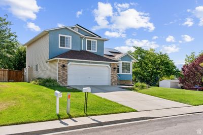 View of front property featuring a garage and solar panels | Image 3