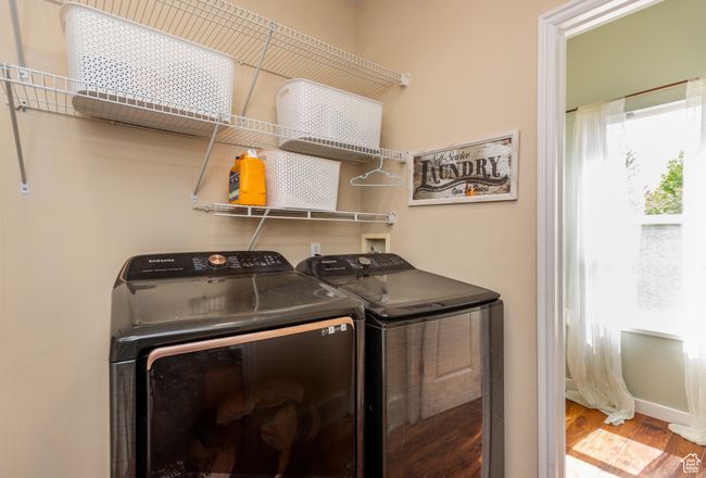 Clothes washing area featuring independent washer and dryer and wood finished floors | Image 13