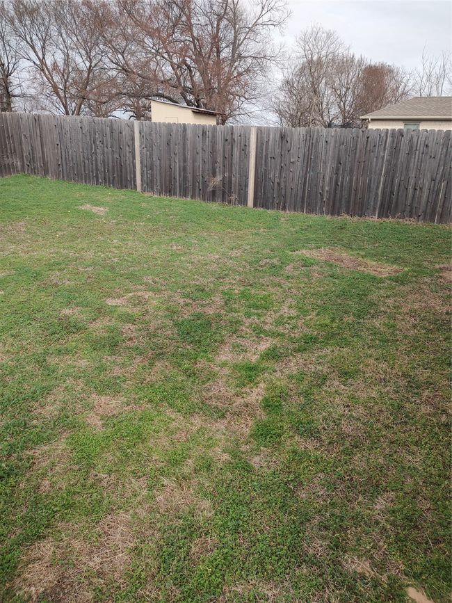 View of fenced backyard | Image 8