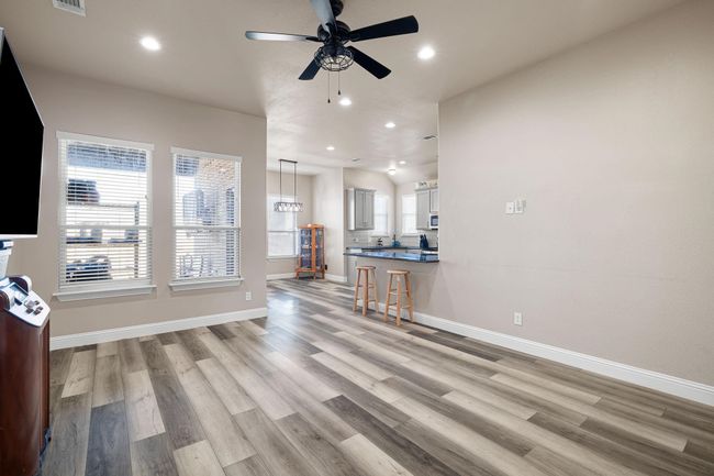 Living room with ceiling fan, recessed lighting, light wood-style flooring, and baseboards | Image 6