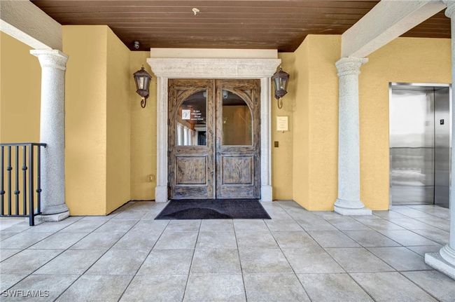 Entrance to property with stucco siding and elevator | Image 41