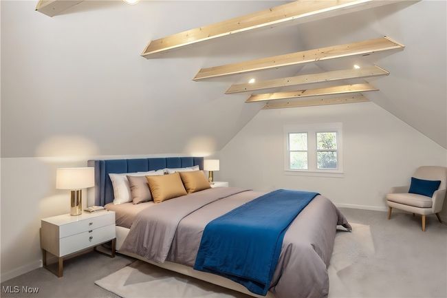Carpeted bedroom featuring lofted ceiling | Image 35