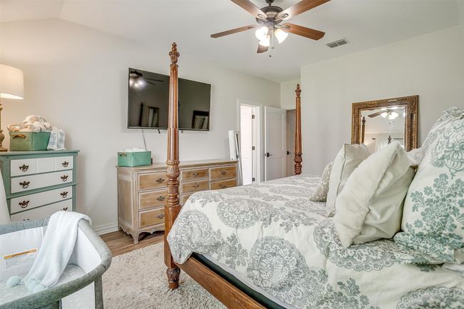Bedroom with light wood-style floors and ceiling fan | Image 22