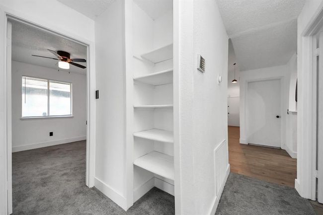 Storage space in hallway leading to bedrooms. | Image 19