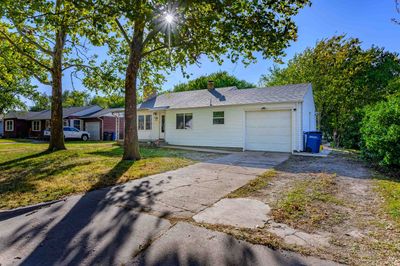 Ranch-style home with a front lawn and a garage | Image 3