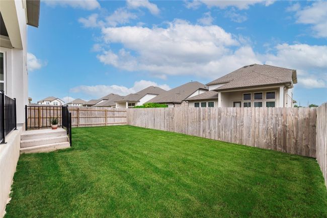 View of yard featuring a fenced backyard and a residential view | Image 25