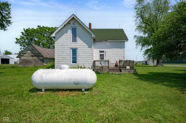 back of property featuring a chimney, a wooden deck, and a yard | Image 17