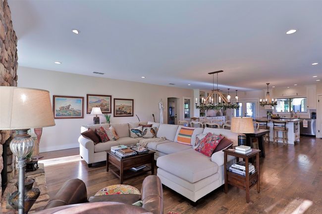 Living area with a chandelier, dark wood-style flooring, and recessed lighting | Image 7