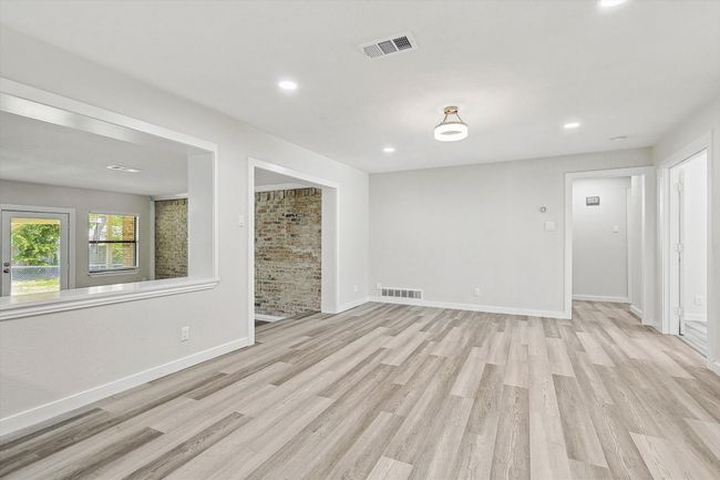 Unfurnished living room featuring visible vents, light wood finished floors, and recessed lighting | Image 14