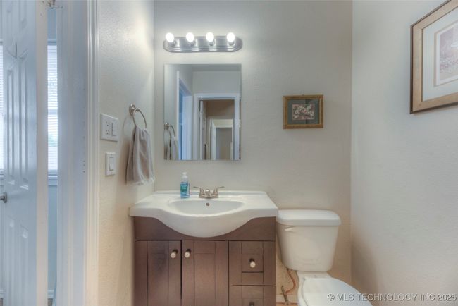 Each side of the bathrooms features their own vanity with sink and toilet. | Image 20