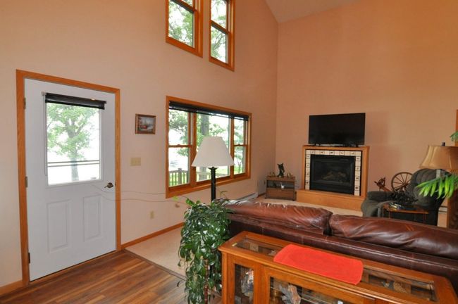 Living room features a propane fireplace. | Image 19