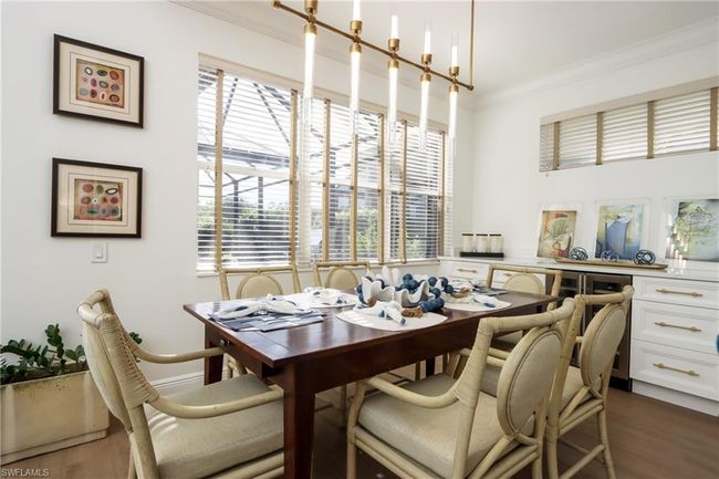Dining space with dark wood-style flooring and ornamental molding | Image 6