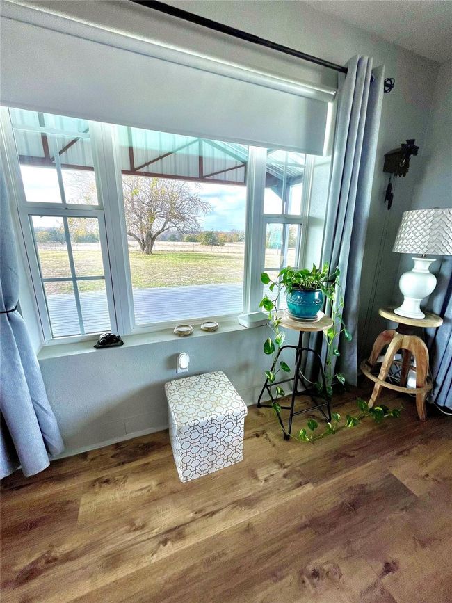 Living area with wood finished floors and healthy amount of natural light | Image 4