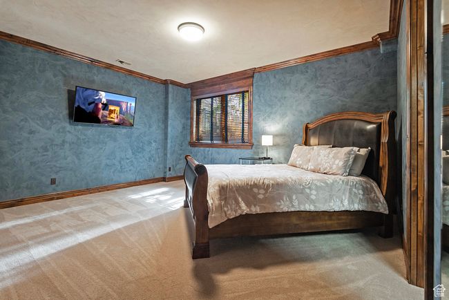 Carpeted bedroom with visible vents, baseboards, and ornamental molding | Image 41