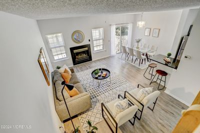 aerial view of living room, dining room, kitchen showing open layout & lots of windows & sllider to let light in | Image 1