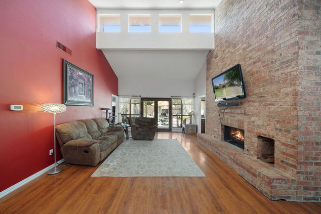 Living room with soaring ceilings and stone fireplace | Image 5