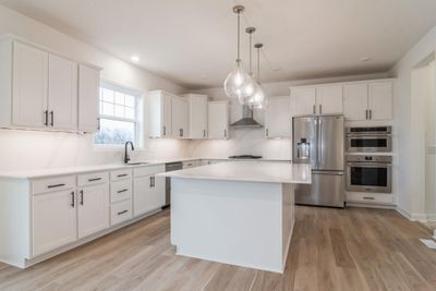 Photo is of the actual home. Imagine cooking a meal in this stunning kitchen! | Image 3