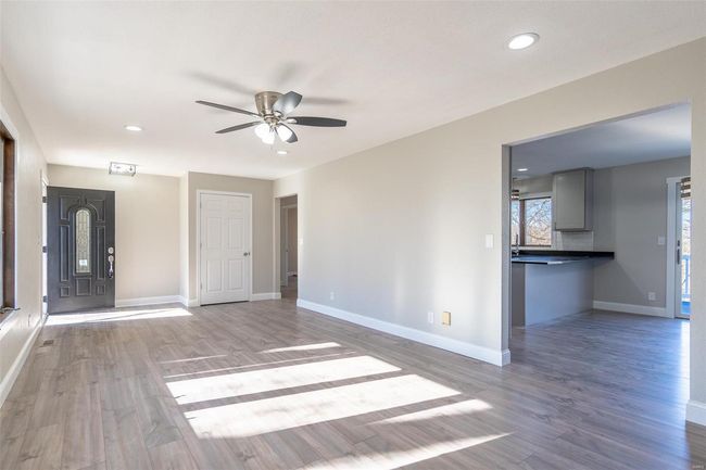Unfurnished living room featuring hardwood / wood-style floors and ceiling fan | Image 33