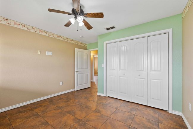 Unfurnished bedroom with a closet and a ceiling fan | Image 17