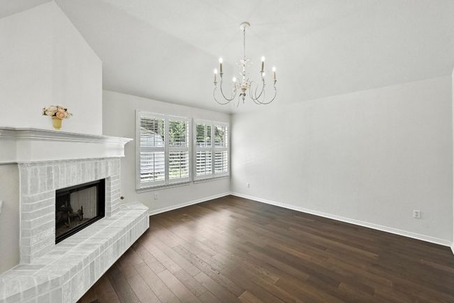 Second living space is right off the kitchen with a fireplace | Image 6