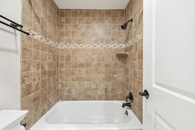 Beautifully tiled shower/tub | Image 16