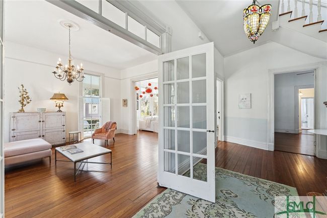French doors separate the foyer from the living room | Image 8