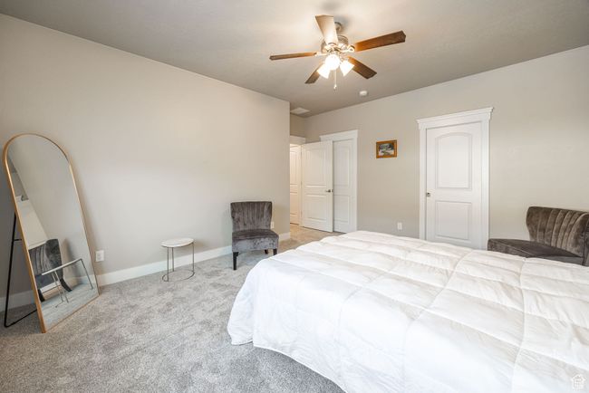 Carpeted bedroom featuring ceiling fan | Image 8