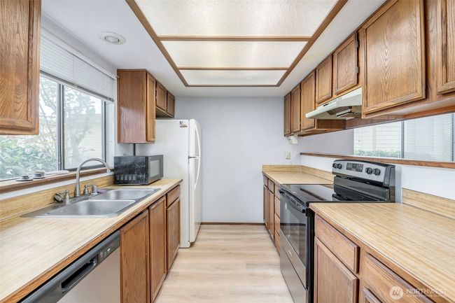New dishwasher, stove, sink, and flooring in the kitchen | Image 4
