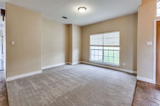 Carpeted empty room with visible vents and baseboards | Image 8