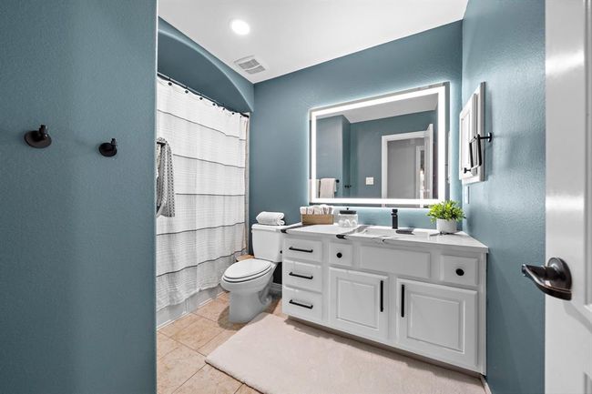 All secondary bathrooms present custom marble countertops, mirrors and cabinet hardware to complete the luxury look. | Image 27
