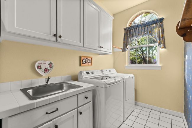 Laundry area with a sink, full sized refrigerator (plus an upright deep freeze in the garage). | Image 25