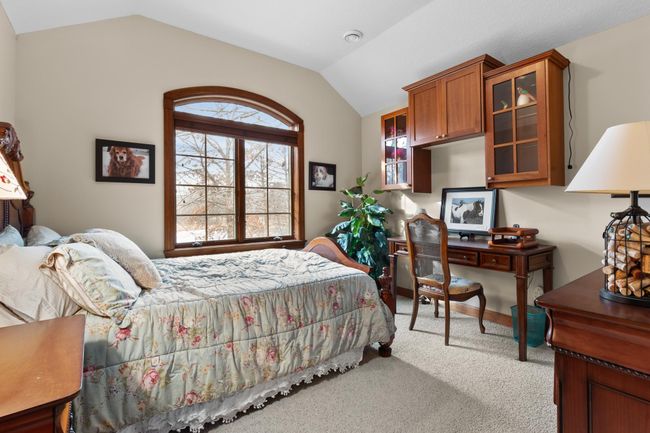 Upper-level second bedroom with view toward front and large natural pond. Walk-in closet. | Image 37