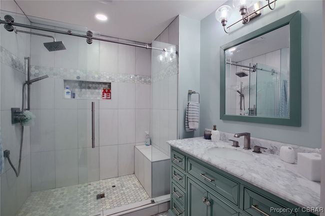 Bathroom featuring vanity and a shower with shower door | Image 47
