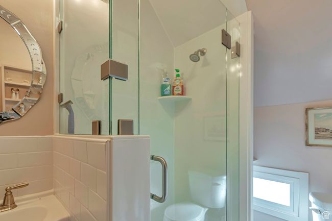 Bathroom featuring toilet, lofted ceiling, and an enclosed shower | Image 29