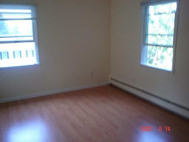 2nd Fl Empty room with wood-type flooring and a baseboard radiator | Image 5