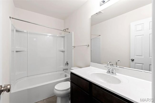 Bathroom featuring vanity and tub / shower combination | Image 23