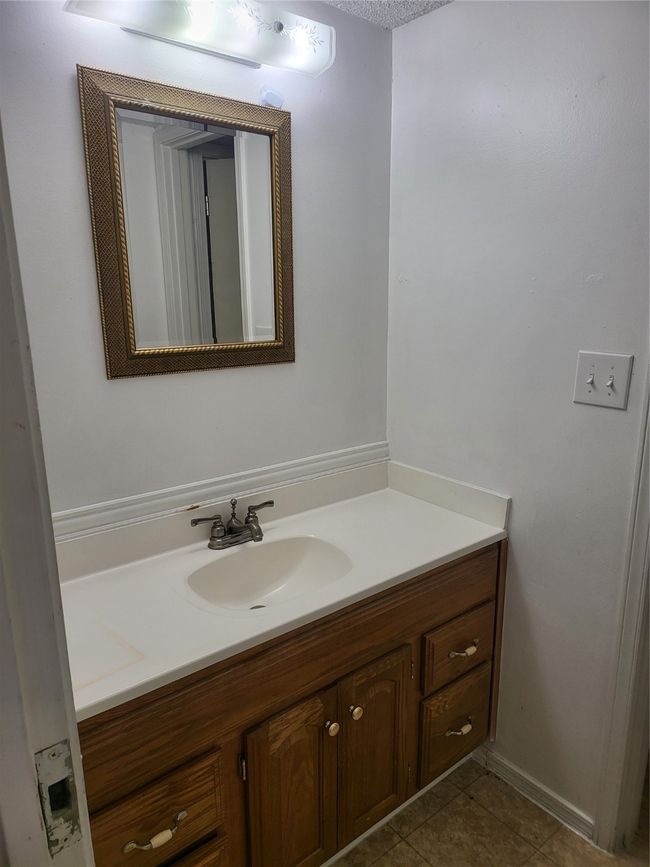 Bathroom featuring tile patterned floors and vanity | Image 10