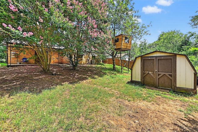 View of yard featuring a storage unit | Image 27