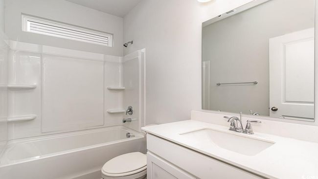 Full bathroom featuring bathing tub / shower combination, toilet, and vanity | Image 6