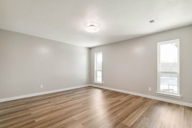 Spare room featuring baseboards and wood finished floors | Image 26