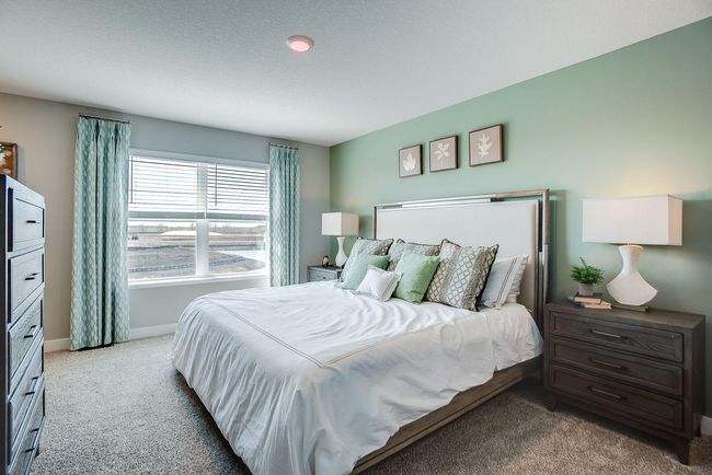 The primary bedroom suite features 2 walk-in closets and its own bathroom with dual sinks and a shower! Photo of model home, colors and selections shown may vary | Image 9