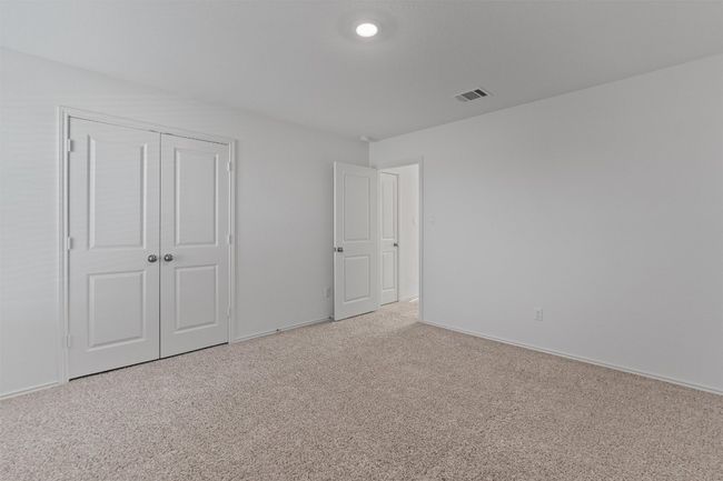 Unfurnished bedroom with baseboards, a closet, visible vents, and light colored carpet | Image 32