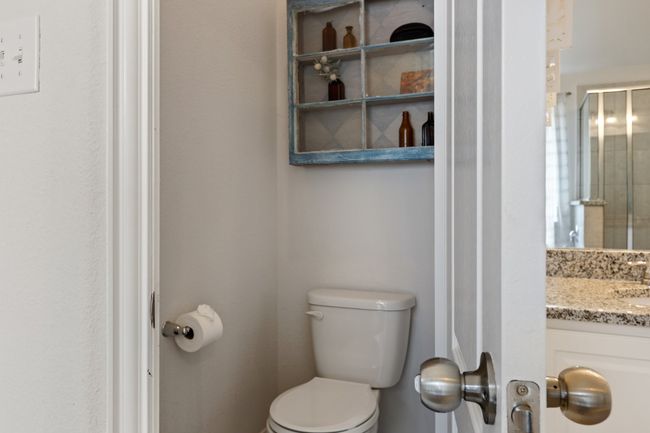 Bathroom featuring vanity, a shower with shower door, and toilet | Image 25